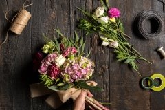 The florist desktop with working tools and ribbons