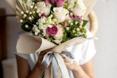 medium-shot-hands-holding-flowers